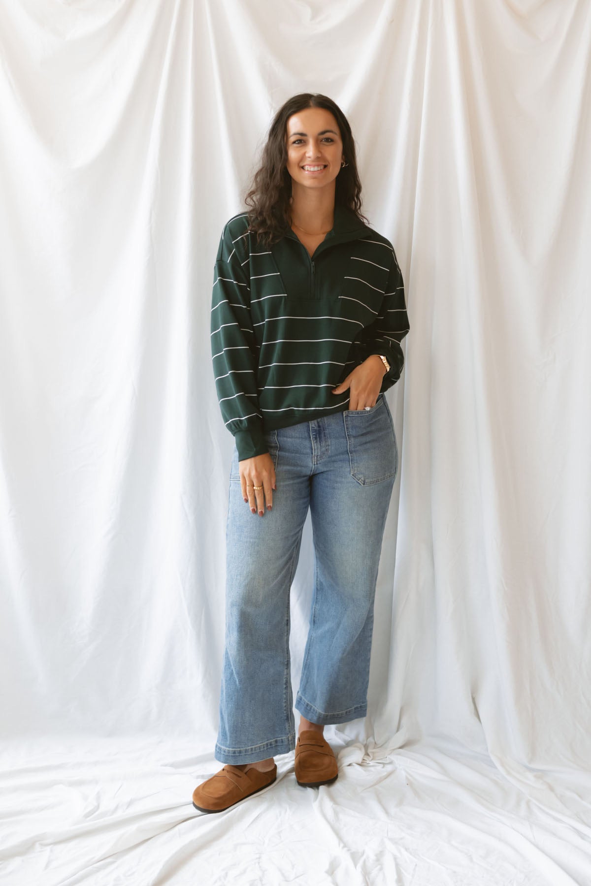 Model is wearing the butter soft stripe quarter zip sweatshirt in green.