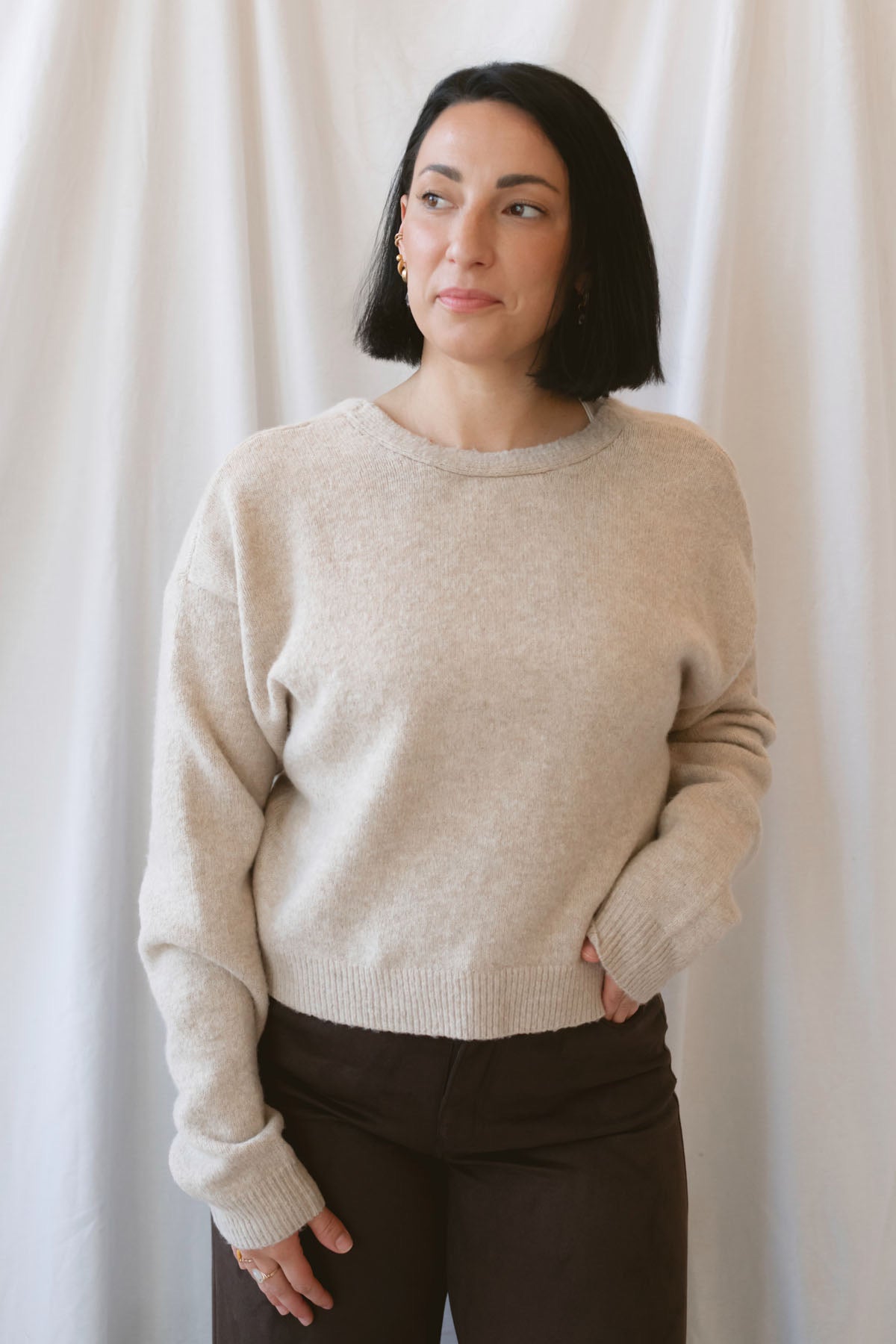 Kayla light taupe knit sweater with a reversible ribbon bow detail, styled with the bow in front.