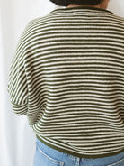 Model wearing striped full button cardigan. Styled fully buttoned up with a pair of classic denim. 