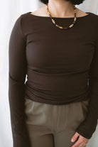 Brynley Boat Neck Micro Ribbed Top in Coffee Bean brown, featuring a feminine boat neckline, subtle ribbed texture, and long sleeves for women's everyday outfits.