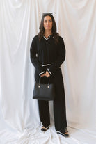 Laura Black Contrast Stripe Trim Collar Knit Sweater and Pants Set featuring a collared sweater and coordinating knit pants with contrasting stripe details.