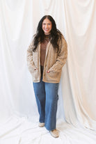 Beige oversized cable knit cardigan for women featuring a collared neckline, textured knit design, and relaxed fit.