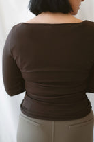 Brynley Boat Neck Micro Ribbed Top in Coffee Bean brown, featuring a feminine boat neckline, subtle ribbed texture, and long sleeves for women's everyday outfits.