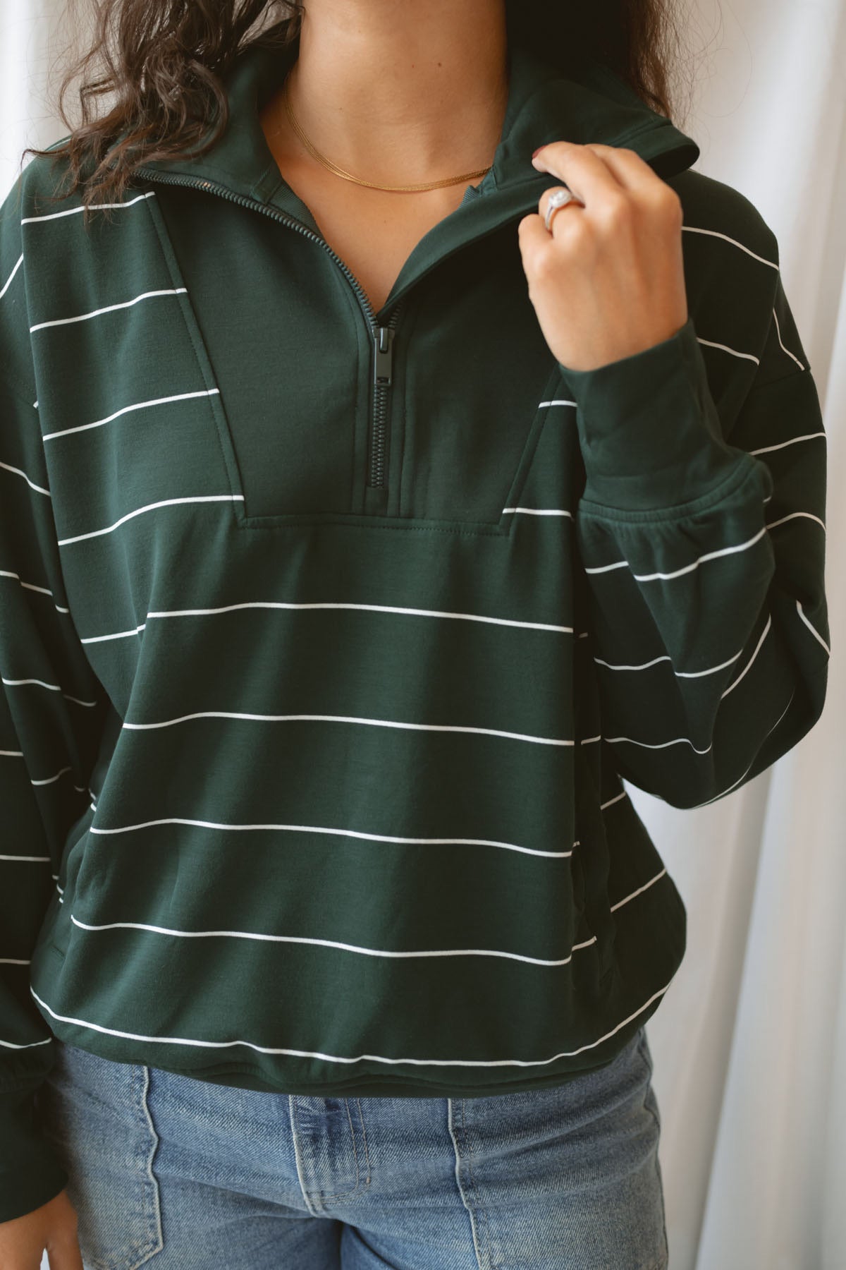 Model is wearing the butter soft stripe quarter zip sweatshirt in green.