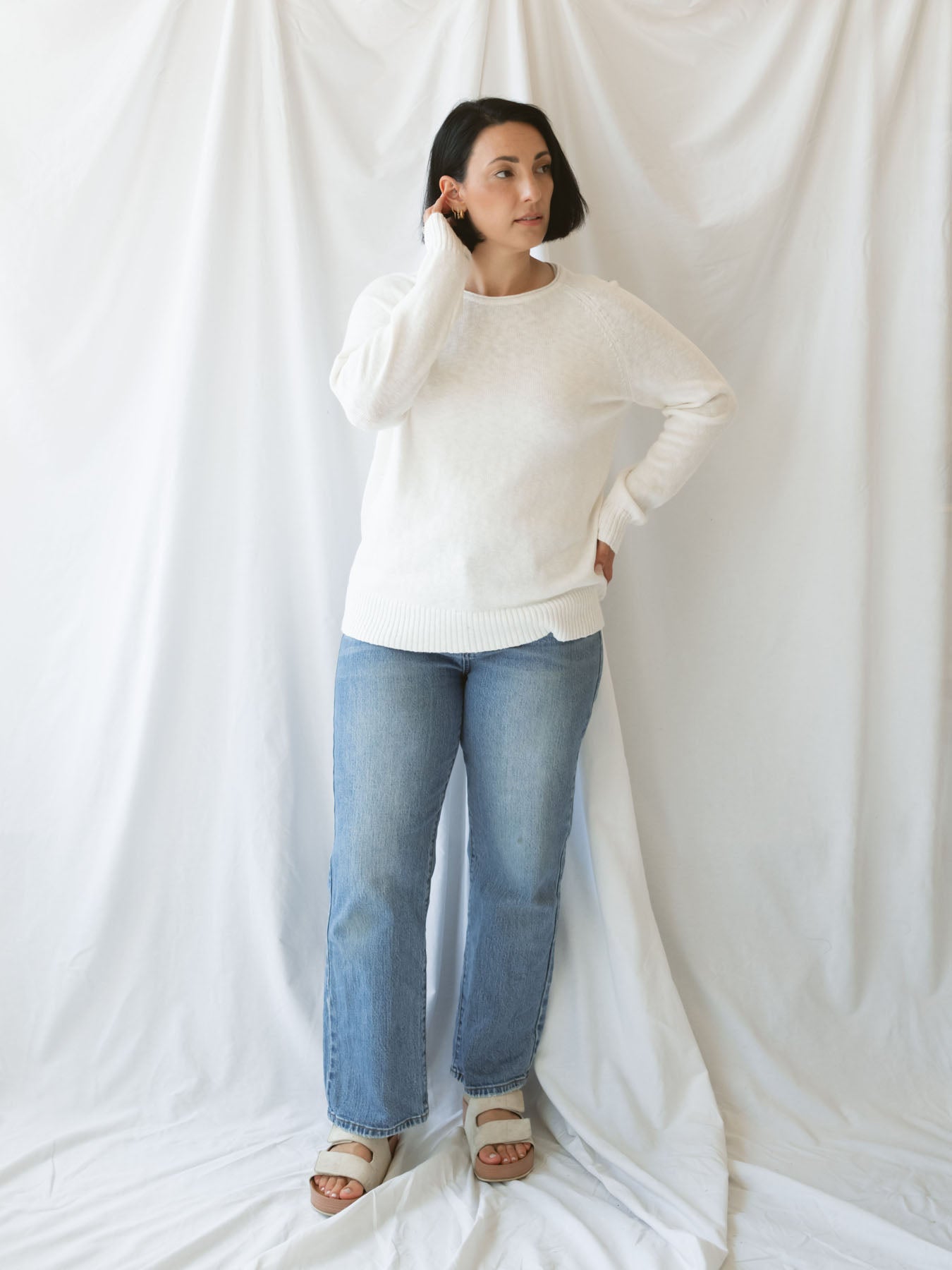Model wearing slub pullover sweater in off white. 