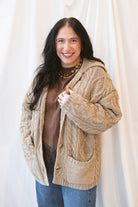 Beige oversized cable knit cardigan for women featuring a collared neckline, textured knit design, and relaxed fit.