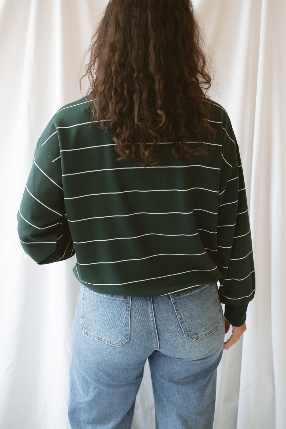 Model is wearing the butter soft stripe quarter zip sweatshirt in green.