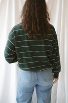 Model is wearing the butter soft stripe quarter zip sweatshirt in green.