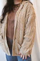 Beige oversized cable knit cardigan for women featuring a collared neckline, textured knit design, and relaxed fit.