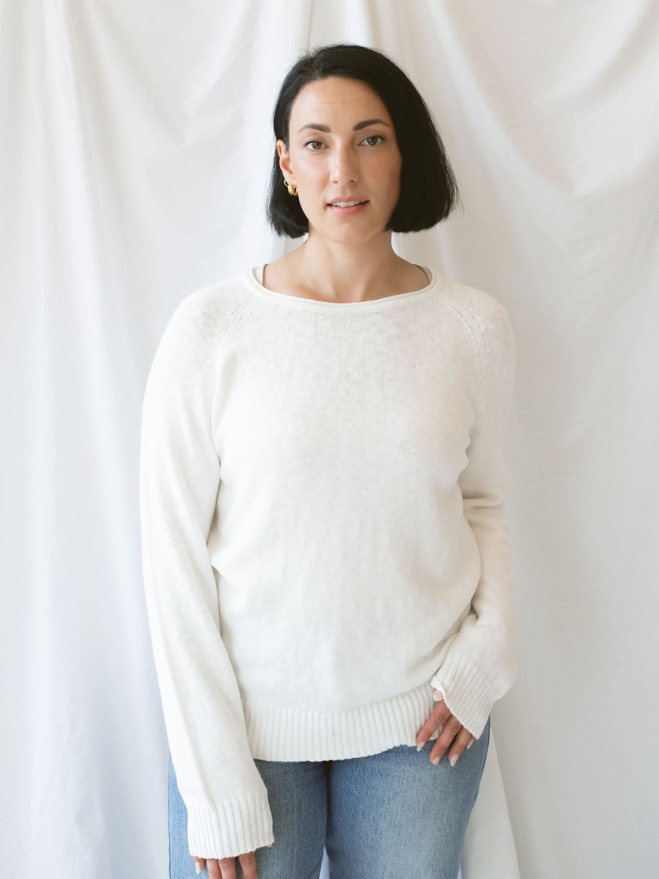 Model wearing slub pullover sweater in off white. 