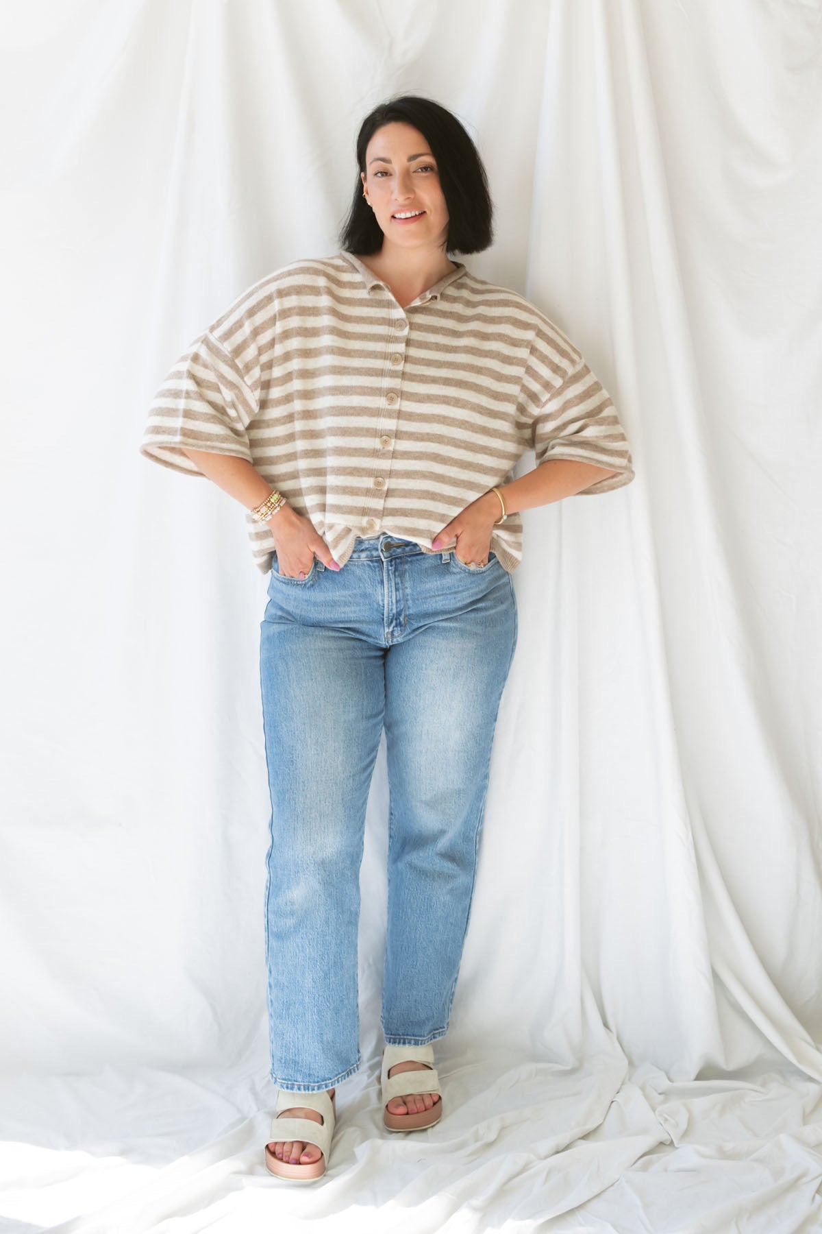 Model wearing stripe raw edge short sleeve button down. 
