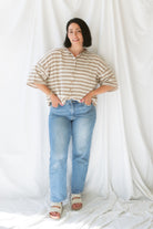 Model wearing stripe raw edge short sleeve button down. 