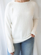 Model wearing slub pullover sweater in off white. 