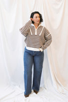 Brown striped half-zip sweater for women featuring a preppy-inspired design, classic stripe pattern, and comfortable knit silhouette for fall and winter outfits.