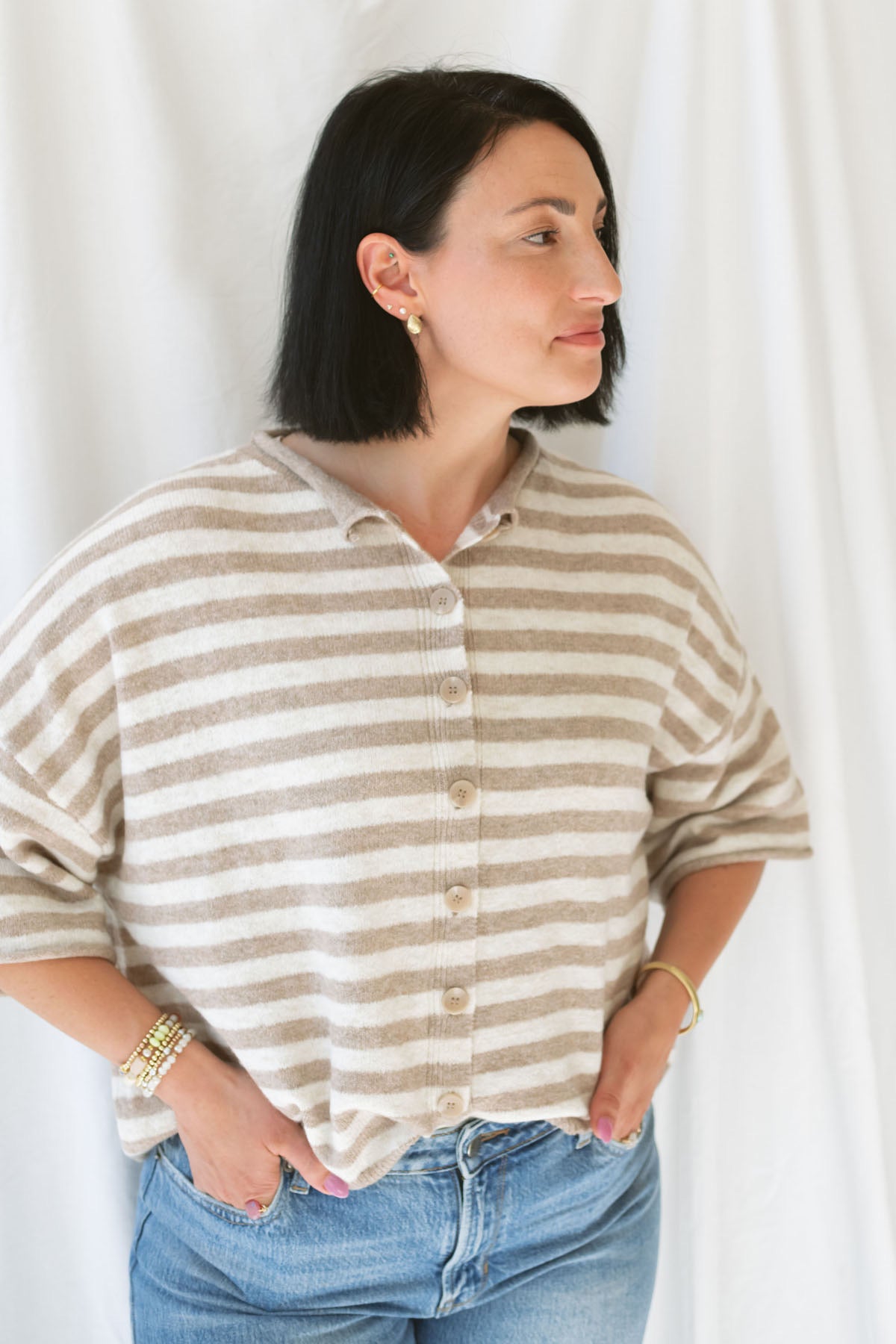 Model wearing stripe raw edge short sleeve button down. 