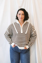 Brown striped half-zip sweater for women featuring a preppy-inspired design, classic stripe pattern, and comfortable knit silhouette for fall and winter outfits.