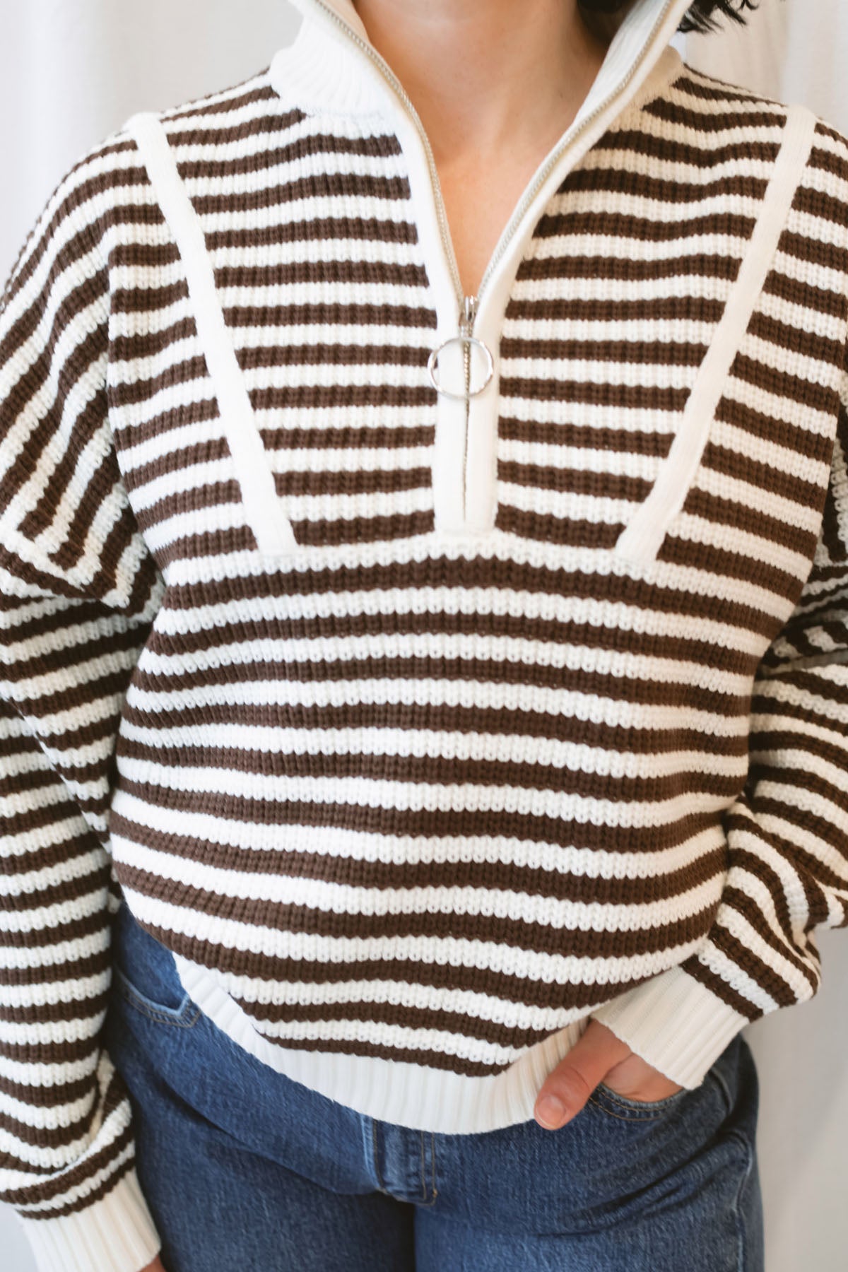 Brown striped half-zip sweater for women featuring a preppy-inspired design, classic stripe pattern, and comfortable knit silhouette for fall and winter outfits.