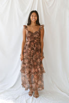 Model wearing the Floral Ruffle Dress in brown. A great fall wedding or event option.