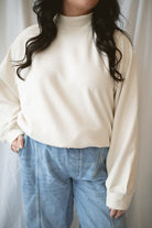 Model wearing the double brushed mock neck pullover. 