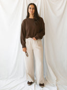 Model wearing textured top with exposed seam detail. A casual option that can be dressed up or down. 