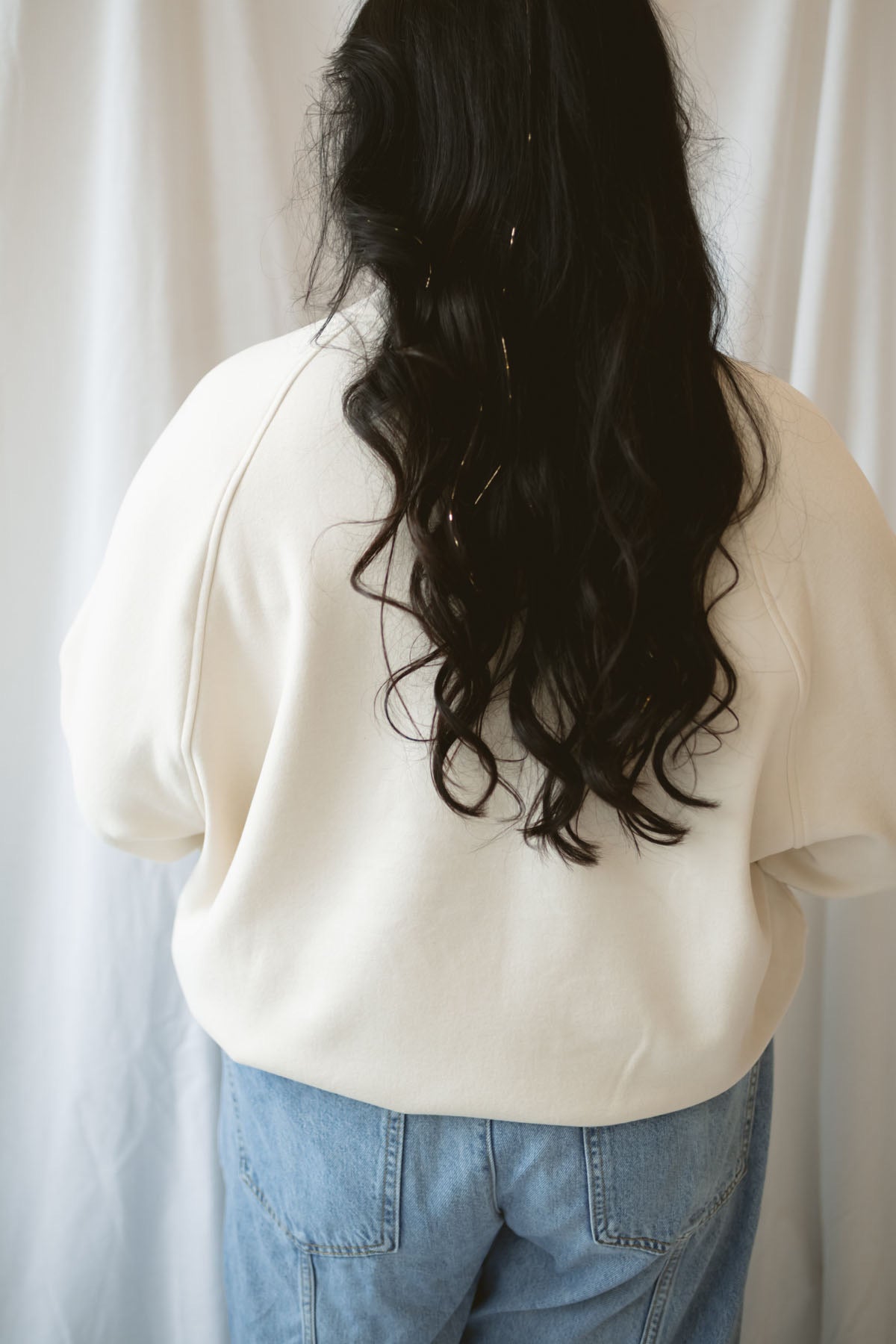 Model wearing the double brushed mock neck pullover. 