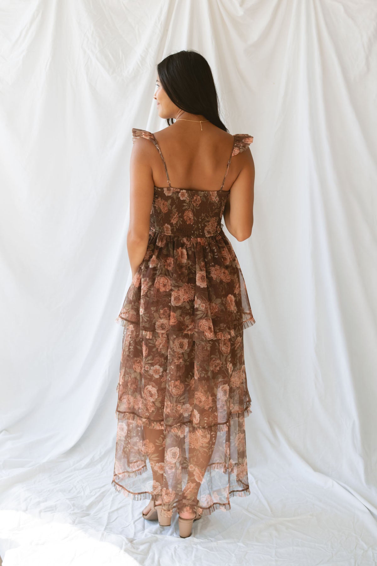 Model wearing the Floral Ruffle Dress in brown. A great fall wedding or event option.