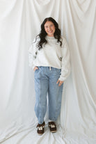 Model wearing the oversized grey crew neck sweatshirt. Model has it styled with a pair of barrel jeans and sneakers for a casual everyday look.