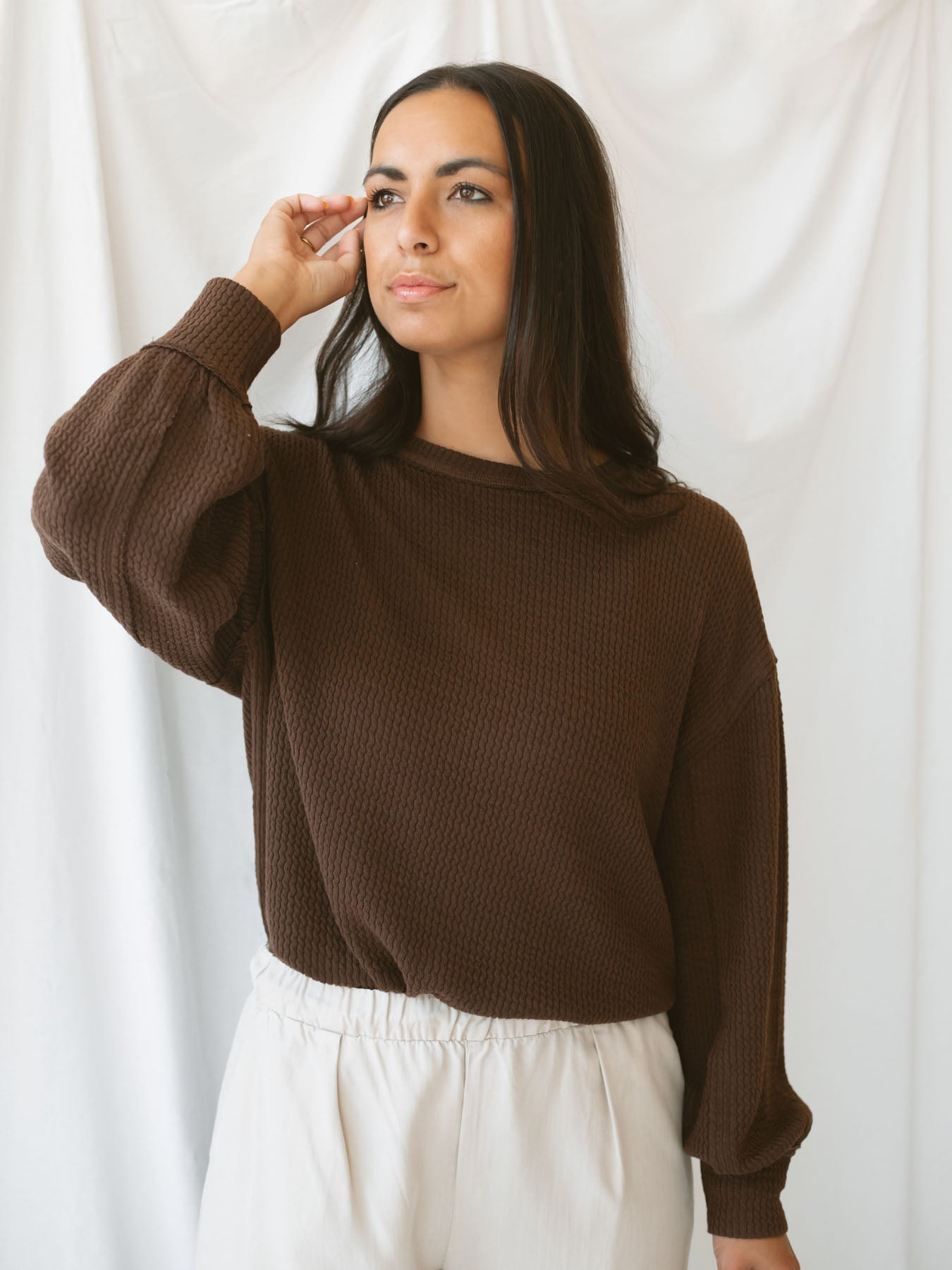 Model wearing textured top with exposed seam detail. A casual option that can be dressed up or down. 