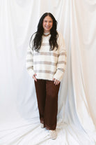 Cream fuzzy knit sweater for women featuring a classic striped pattern, relaxed boyfriend fit, and cozy textured finish for casual fall and winter styling.