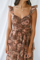 Model wearing the Floral Ruffle Dress in brown. A great fall wedding or event option.