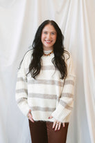 Cream fuzzy knit sweater for women featuring a classic striped pattern, relaxed boyfriend fit, and cozy textured finish for casual fall and winter styling.
