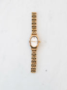 Gold round face watch 