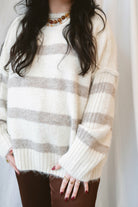 Cream fuzzy knit sweater for women featuring a classic striped pattern, relaxed boyfriend fit, and cozy textured finish for casual fall and winter styling.