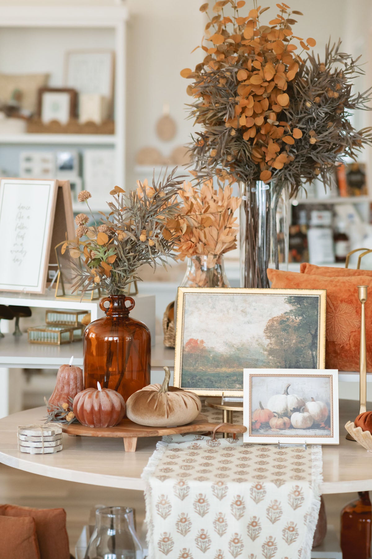 Yellow two tone faux eucalyptus stem styled with the light brown thistle spray and other warm autumn decor.