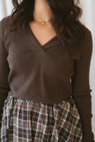 Ronny chocolate brown long sleeve ribbed knit top with an open collar neckline.