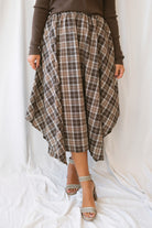 Riley brown plaid midi skirt with an asymmetrical hem and classic autumn pattern.