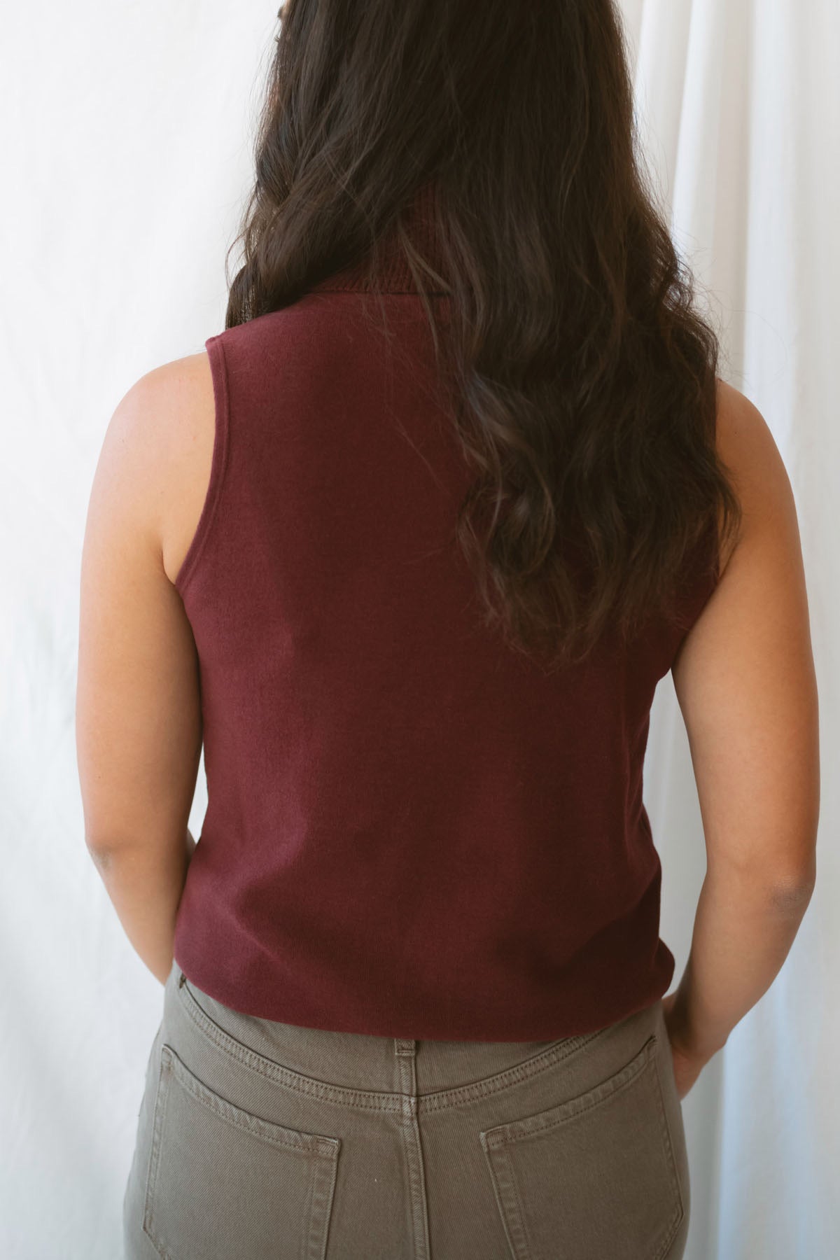 Kori Sleeveless Turtle Neck Soft Knit Top in Maroon featuring a sleeveless silhouette and classic turtle neckline.