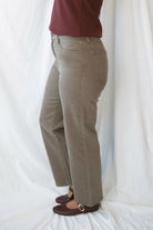 Model wearing the straight leg denim in brown.