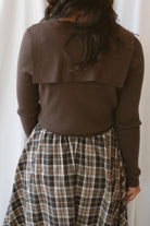 Ronny chocolate brown long sleeve ribbed knit top with an open collar neckline.