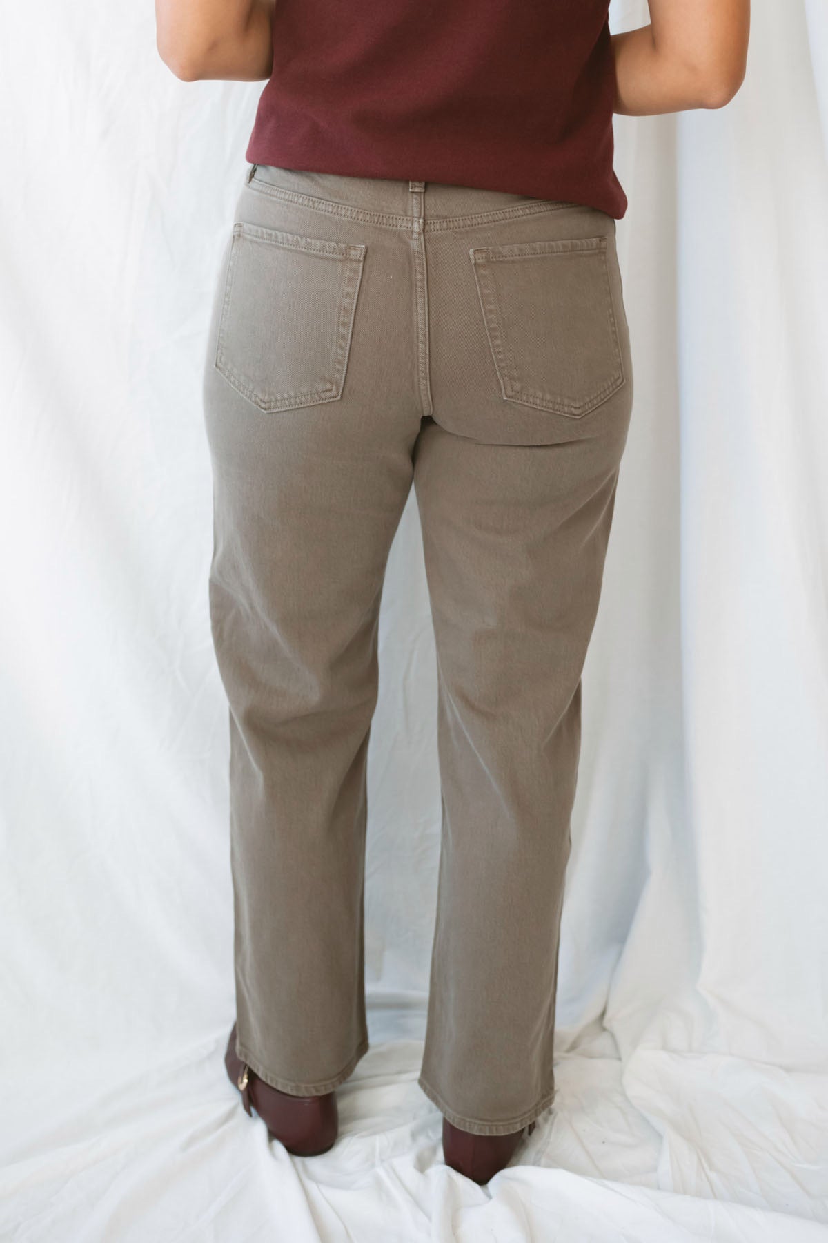 Model wearing the straight leg denim in brown.