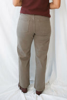 Model wearing the straight leg denim in brown.