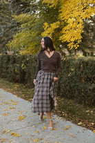 Riley brown plaid midi skirt with an asymmetrical hem and classic autumn pattern.
