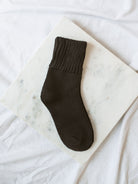 Dark Coffee Brown Colored Crew Socks laying on marble board. 