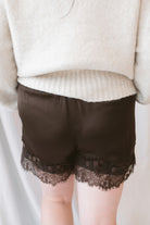 Autumn Waistband Lace Trim Hem Satin Shorts in brown with a smooth satin finish and delicate lace trim along the hem.