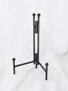 Black metal straight back simple table top easel. Great for frames photos or artwork, plates, cookbooks and more. 