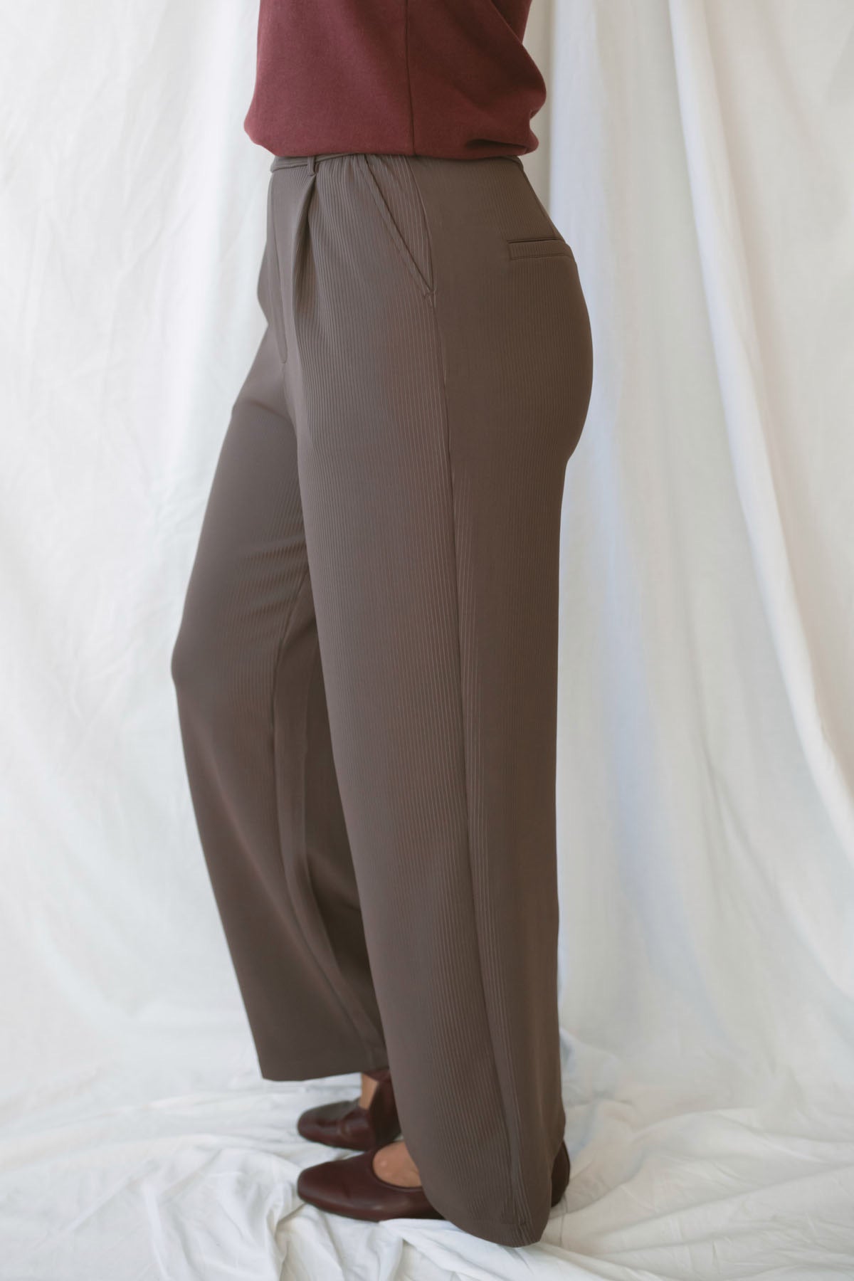 Model wearing the ribbed tailored trousers. 