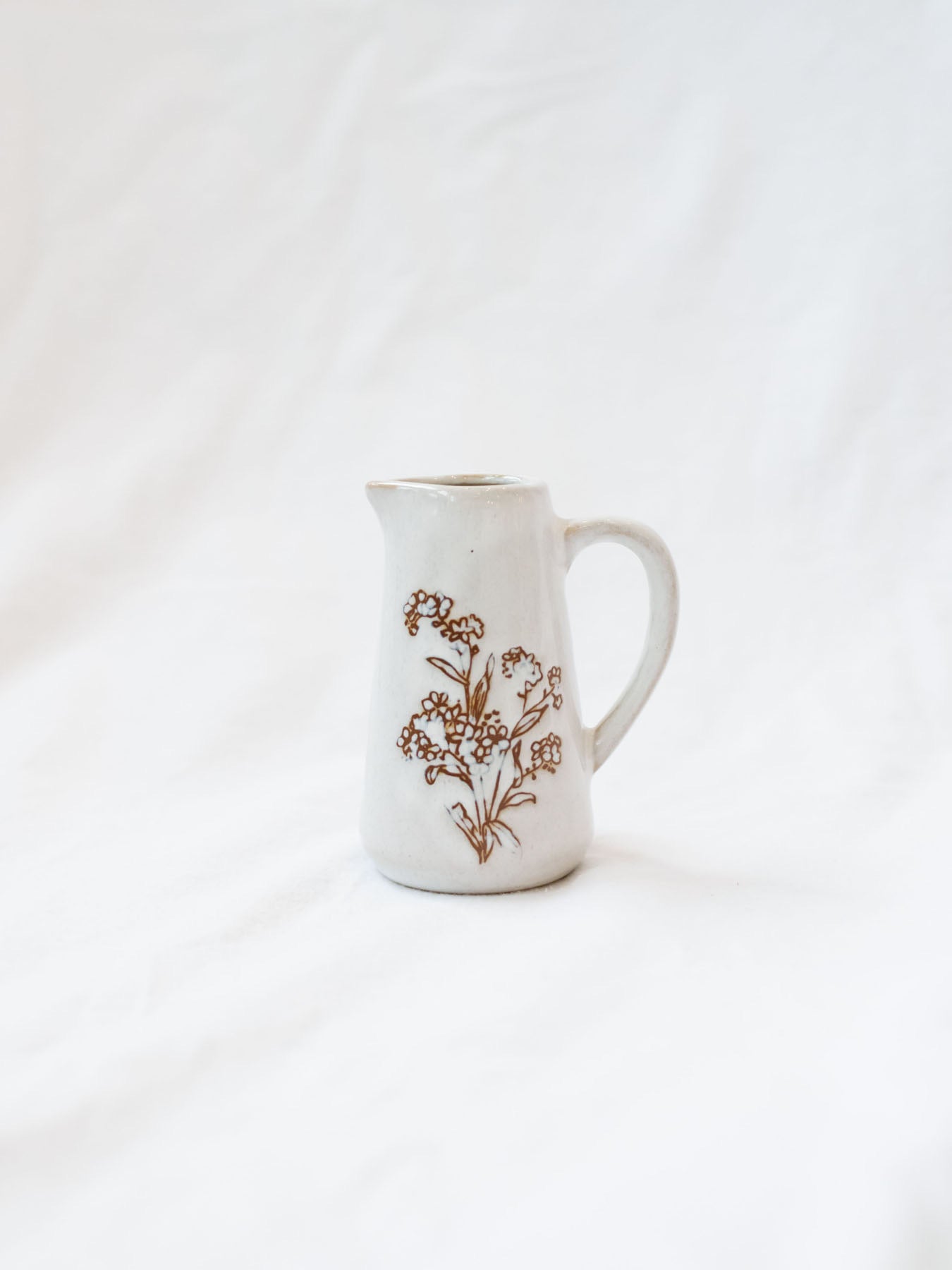 Style 1 of the mini floral pitcher. Set up against a white linen backdrop. 