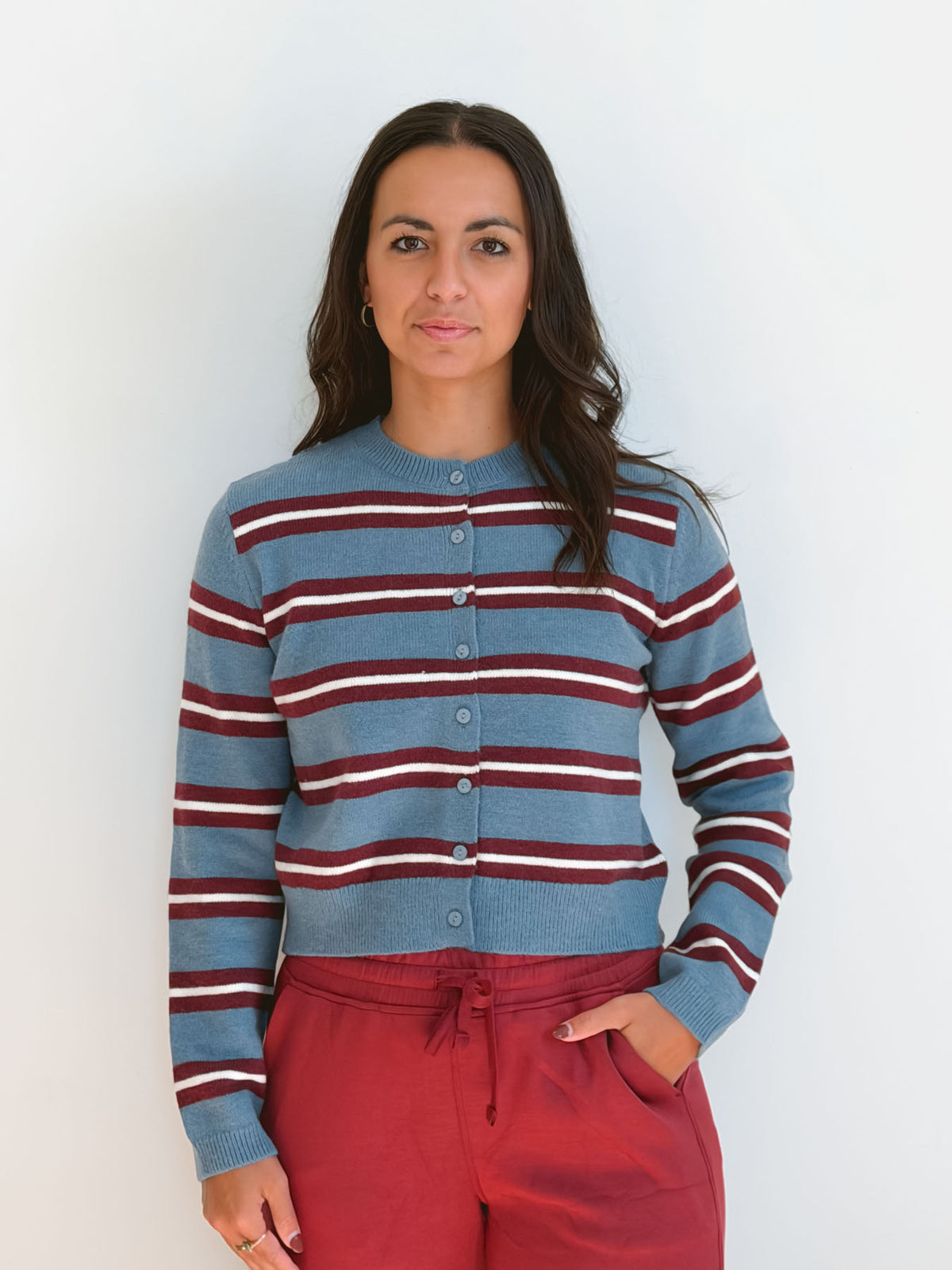 Model wearing long sleeve full button down striped cardigan.