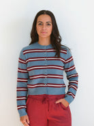 Model wearing long sleeve full button down striped cardigan.