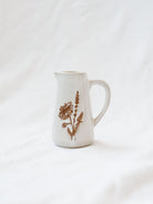 Style 2 of the mini floral pitcher. Set up against a white linen backdrop. 
